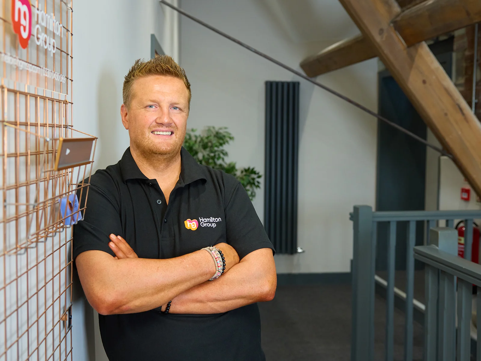 Hamilton Group team leader standing confidently in the office.