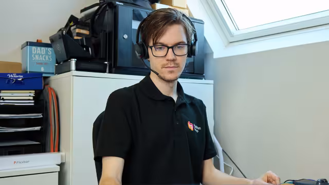 Hamilton Group IT engineer assisting clients via headset.