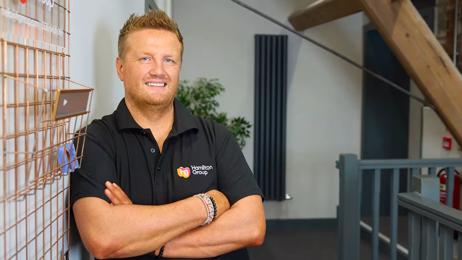 Hamilton Group team leader standing confidently in the office.