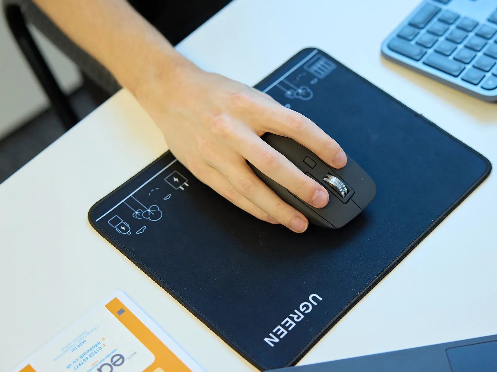 Hamilton Group engineer using a wireless mouse at their workstation.