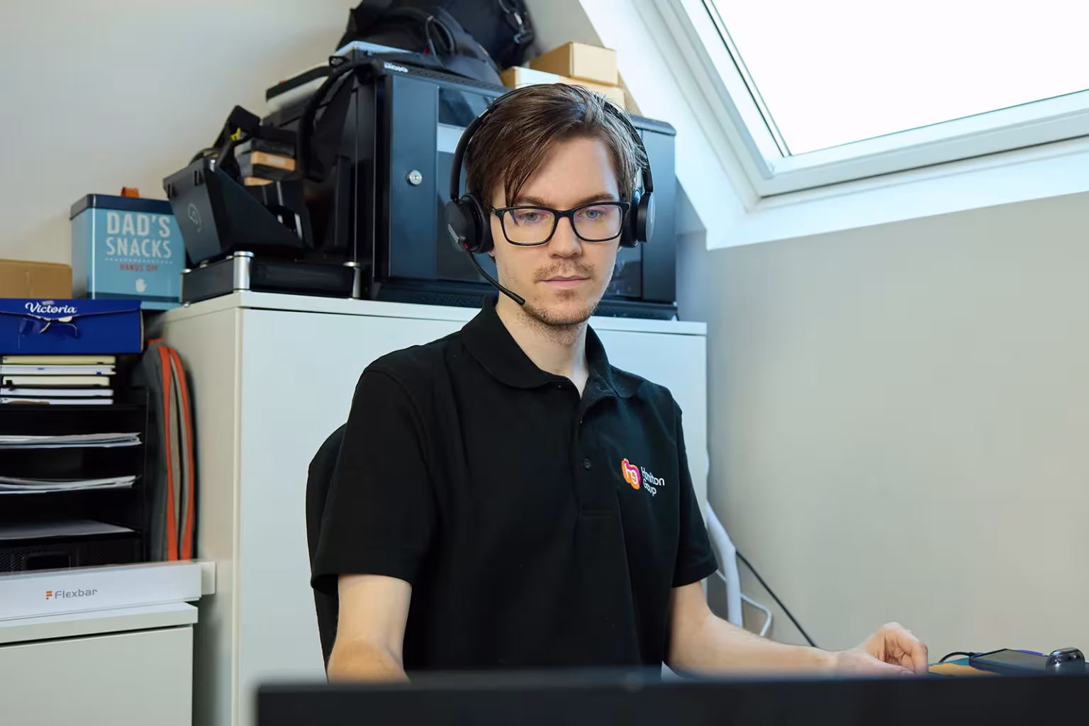 Hamilton Group IT engineer assisting clients via headset.