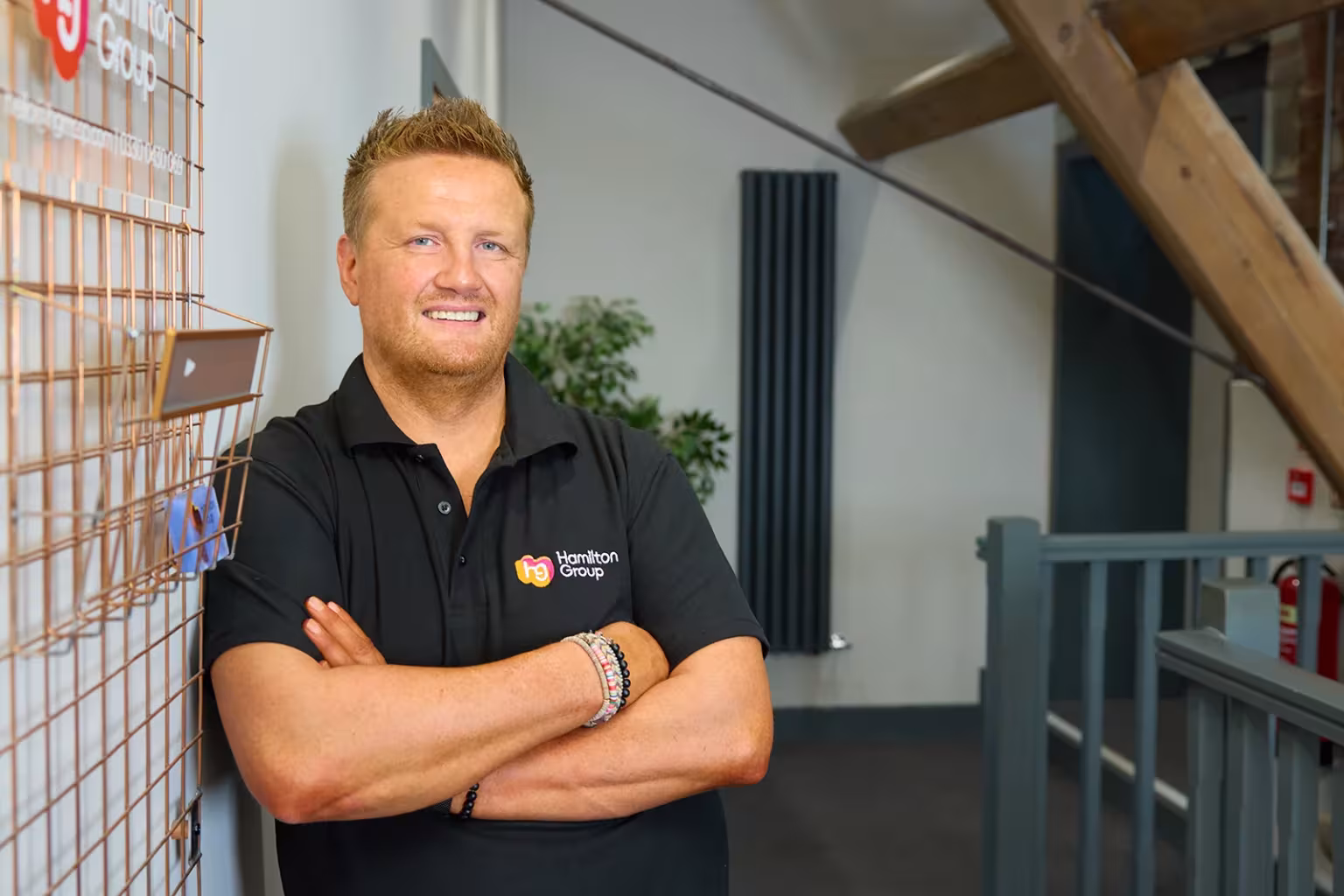 Hamilton Group team leader standing confidently in the office.