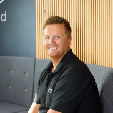Hamilton Group team leader sitting in the lounge area at company headquarters.